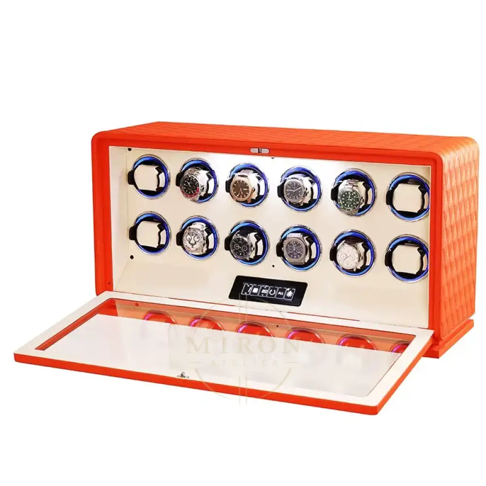 Orange watch winder with multiple watch cases on a white background