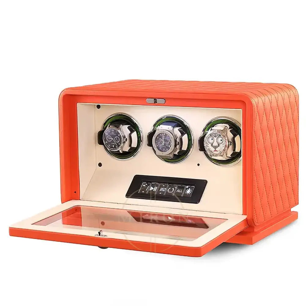 Orange watch winder with three watches on a white background