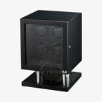 Black watch winder, cubic form with four watches on a white background