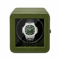 Patek Philippe Watch in a green watch winder case on a white background