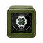 Patek Philippe Watch in a green watch winder case on a white background