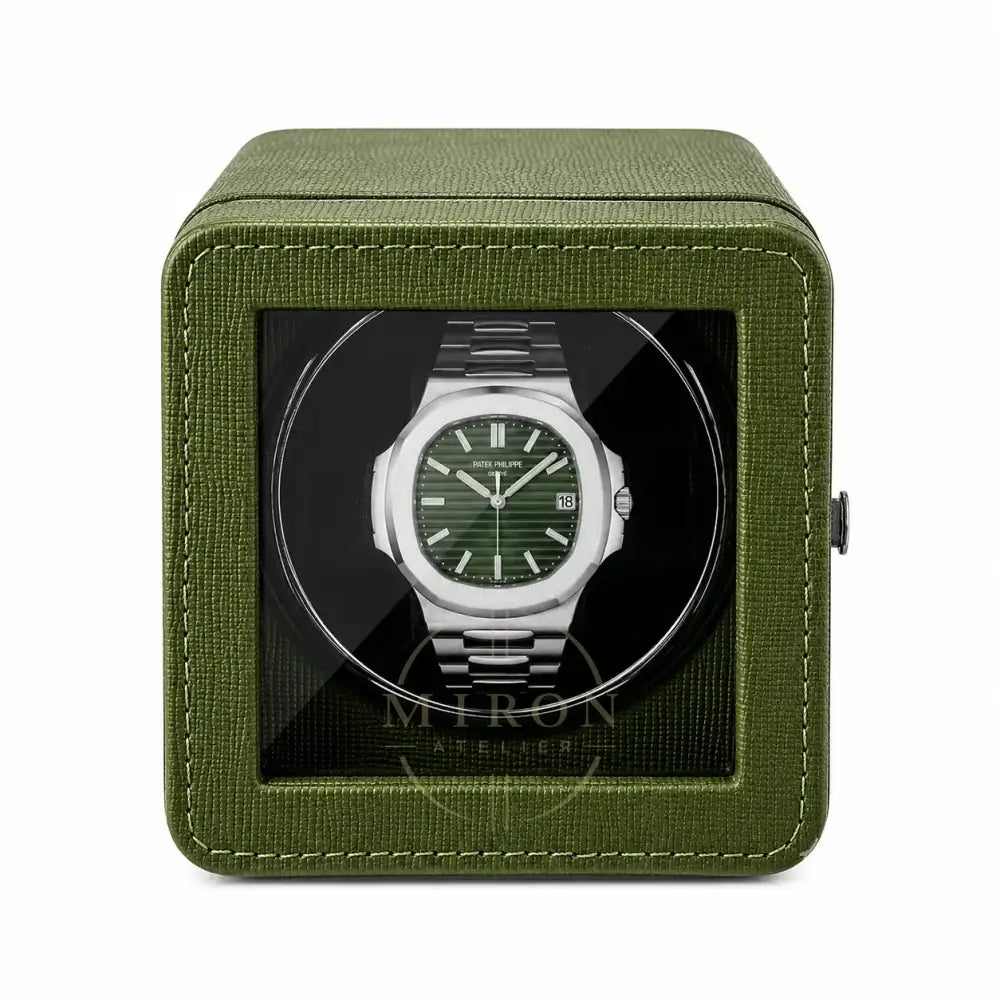 Patek Philippe Watch in a green watch winder case on a white background