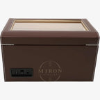 Brown leather jewelry box with a glass lid on a white background