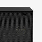 Black corner of watch winder with textured surface 