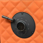 Black dial on an orange quilted surface