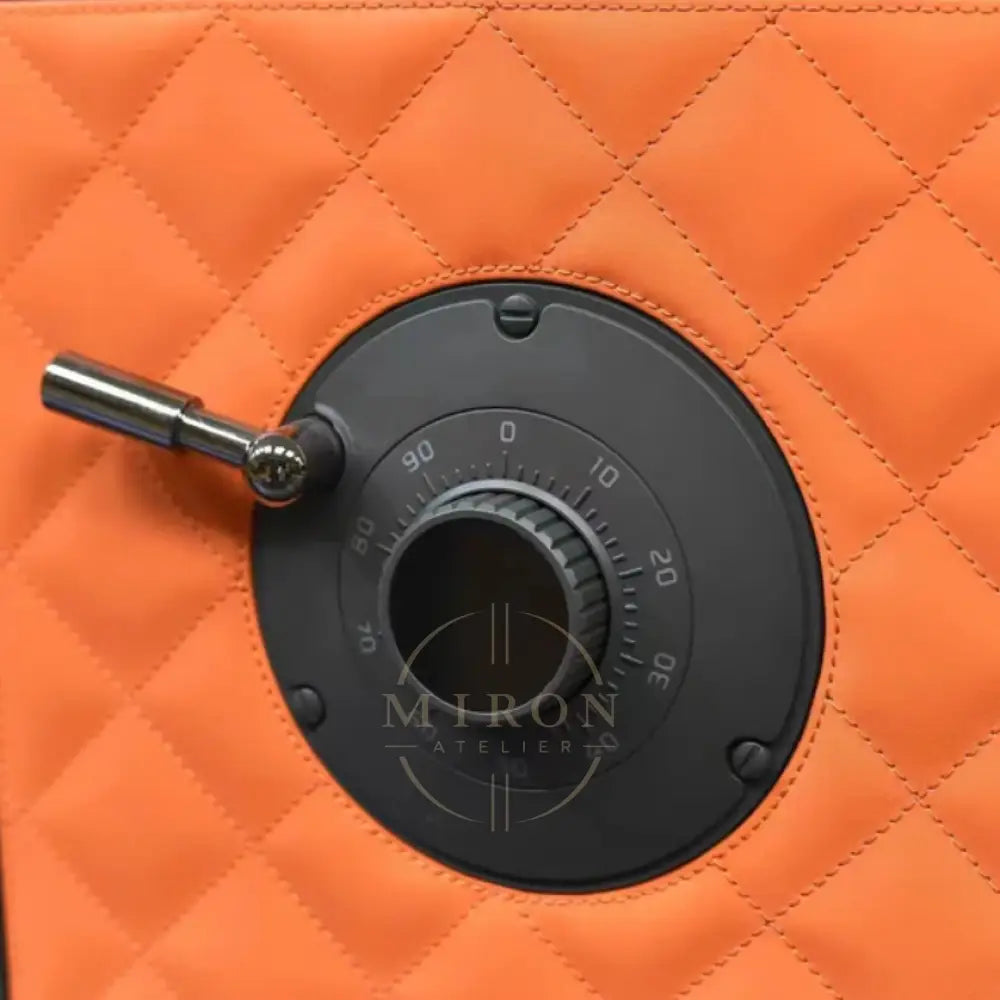 Black dial on an orange quilted surface