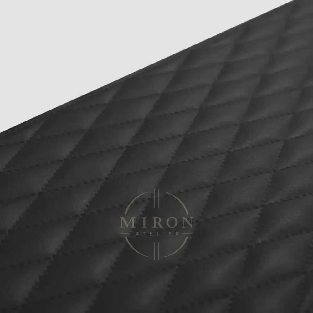 Close-up of a black quilted fabric texture of watch winder 