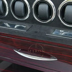 Close-up of a watch winder's interior panel with drawer and rotators.