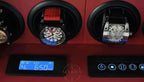 Watch winder with two watches inside and digital display on a red background