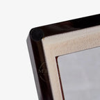 Close-up of a wooden picture frame corner on a white background