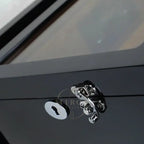 Close-up of a metallic door handle and lock on a watch winder