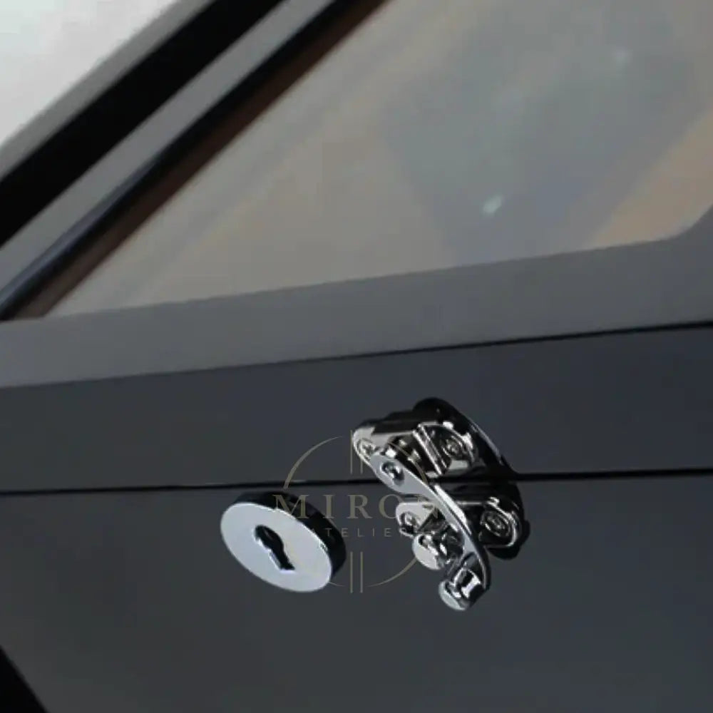 Close-up of a metallic door handle and lock on a watch winder