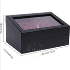 Black watch box with glass lid displaying watches, shown with dimensions on a white background.
