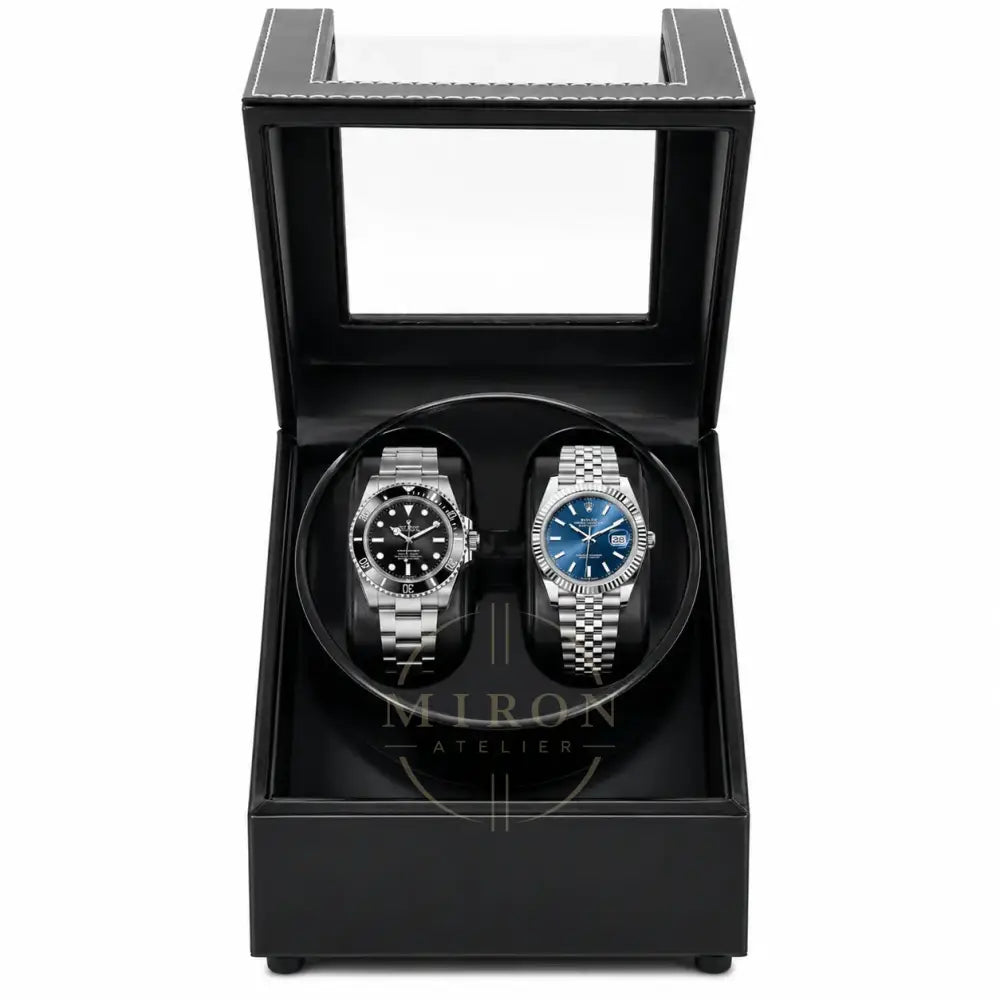 Two luxury watches in a black leather watch winder box.