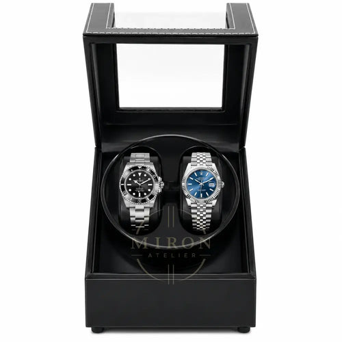 Two luxury watches in a black leather watch winder box.