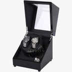 Black watch winder with two watches inside on a white background