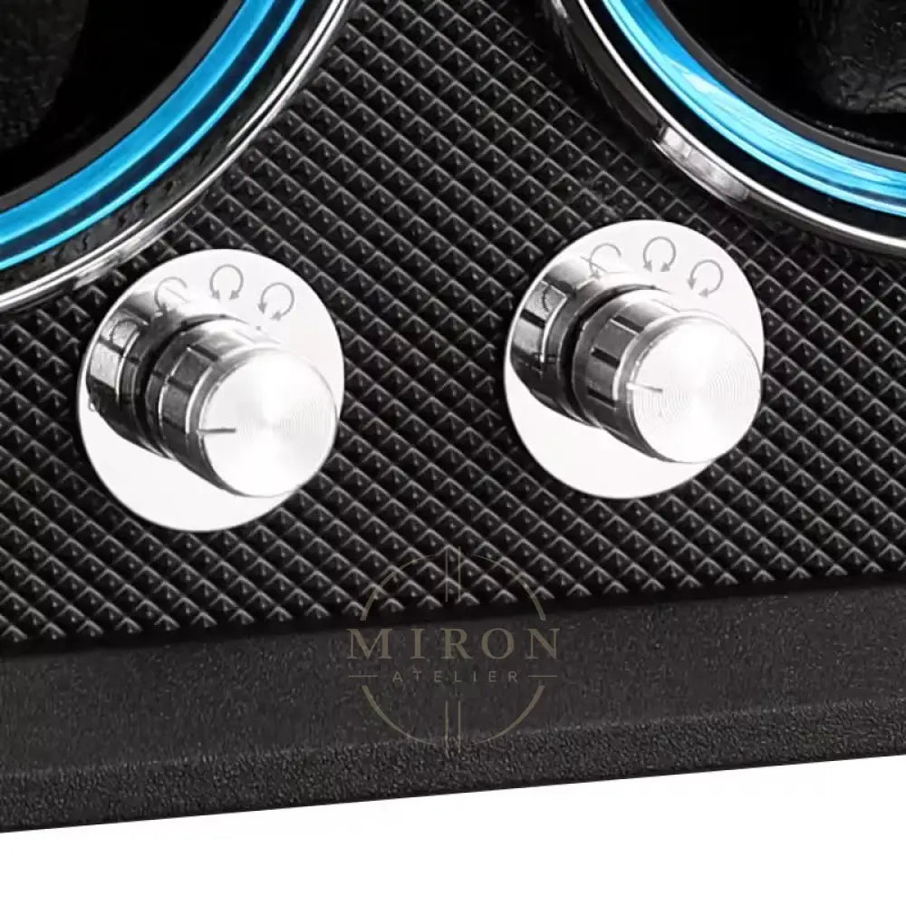 Close-up of two silver knobs on a black textured surface with blue accents.
