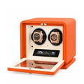 Orange watch winder with two watches inside on a white background