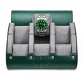 A green leather watch roll stand with a gray velvet interior, shown open and holding a Rolex Hulk watch with a green dial and bezel.
