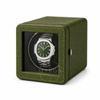 Green watch winder with a luxury Patek Philippe watch inside 