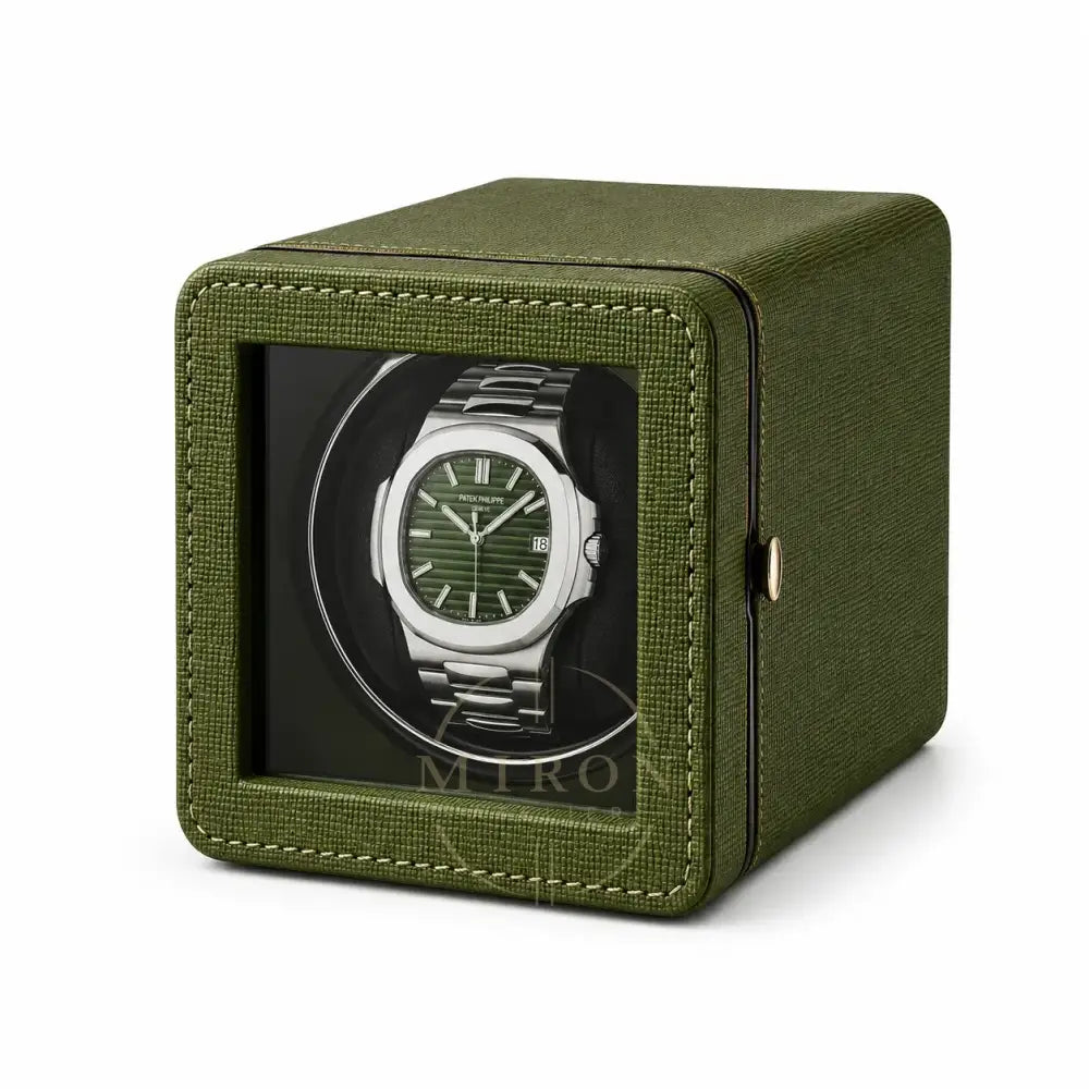 Green watch winder with a luxury Patek Philippe watch inside 