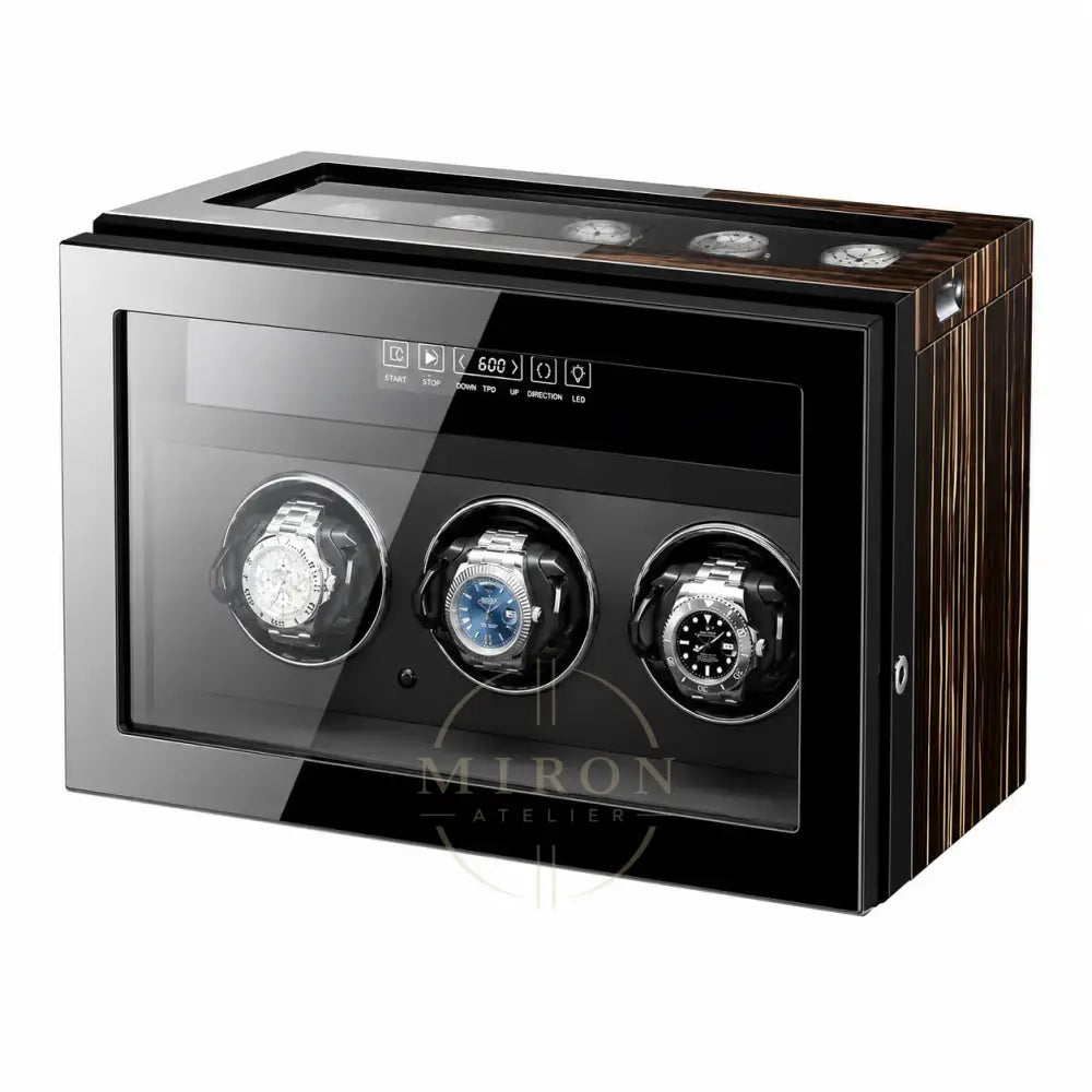 Watch winder with three watches on a white background