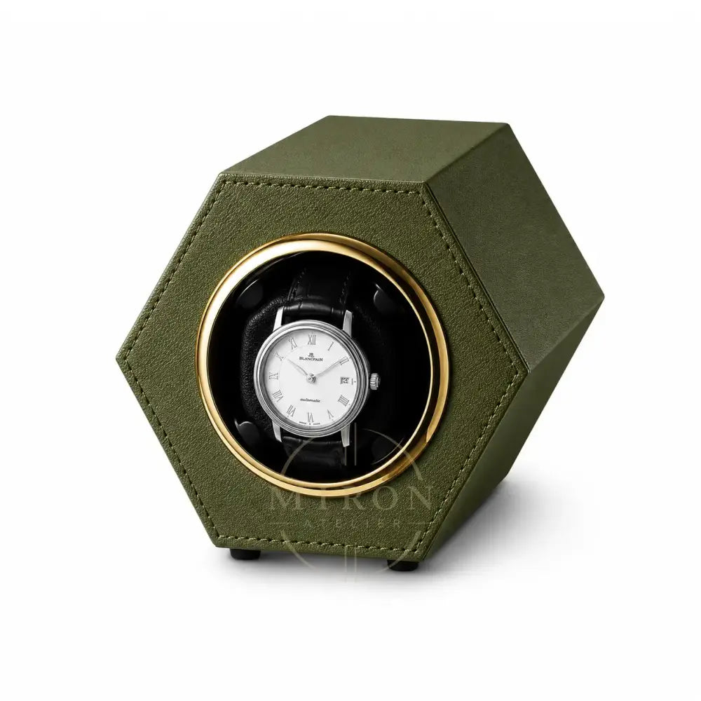 Green hexagonal watch winder with a automatic luxury watch inside on a white background