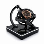 Omega Watch rotating on a black orbital watch winder. 