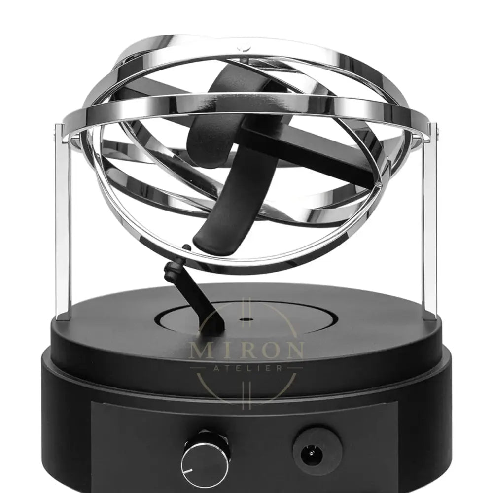 Black and silver magnetic levitation orb for watch winder on a white background