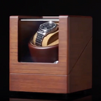 Wooden watch winder with a Tissot Watch inside. 