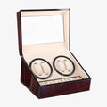 Luxury rosewooden watch winder box with glass lid and two watch compartments on a white background