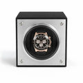 Watch winder with a black and rose gold Rolex Daytona watch inside on a white background