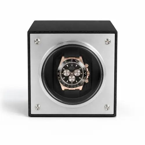 Watch winder with a black and rose gold Rolex Daytona watch inside on a white background