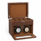 Brown watch winder with two watches inside on a white background
