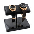 Two gold luxury watches Audemars Piguet on a black marble watch stand with a white background