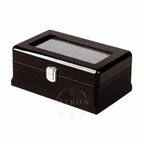 A rectangular dark wood watch box with a glossy finish, a clear glass window on top, and a silver metal latch, shown on a plain white background.