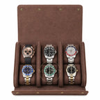 A brown suede watch roll travel storage with six cushioned slots, shown open and filled with six different luxury watches on a white background.