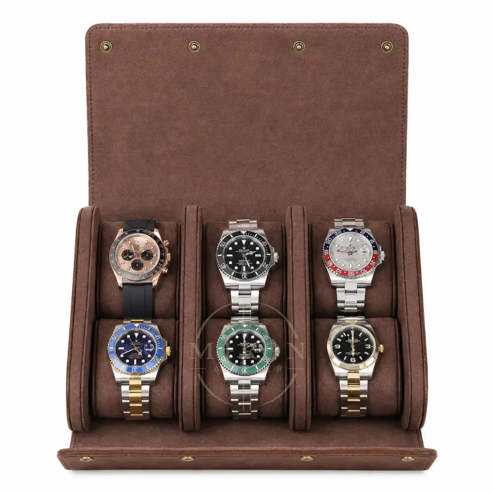 A brown suede watch roll travel storage with six cushioned slots, shown open and filled with six different luxury watches on a white background.