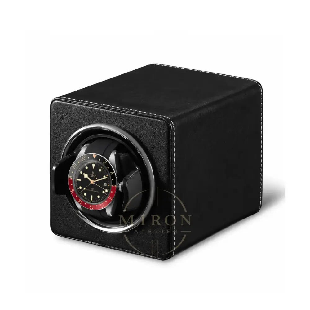Black watch winder with a Tudor watch inside on a white background