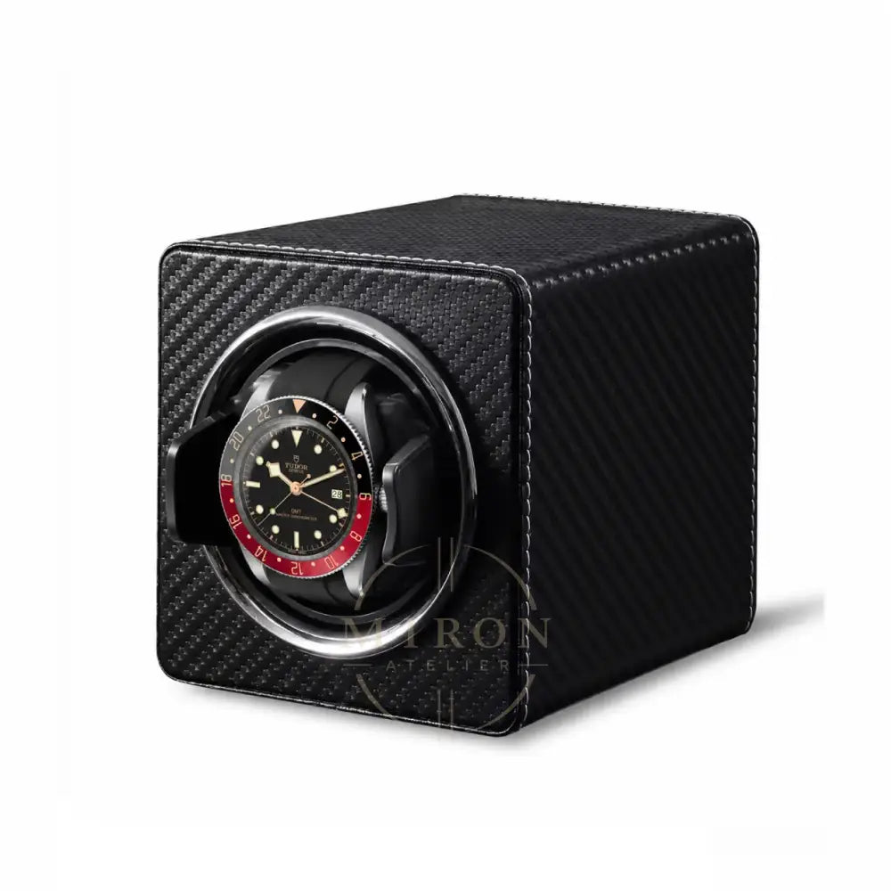 Carbon watch winder with a luxury Tudor watch inside on a white background