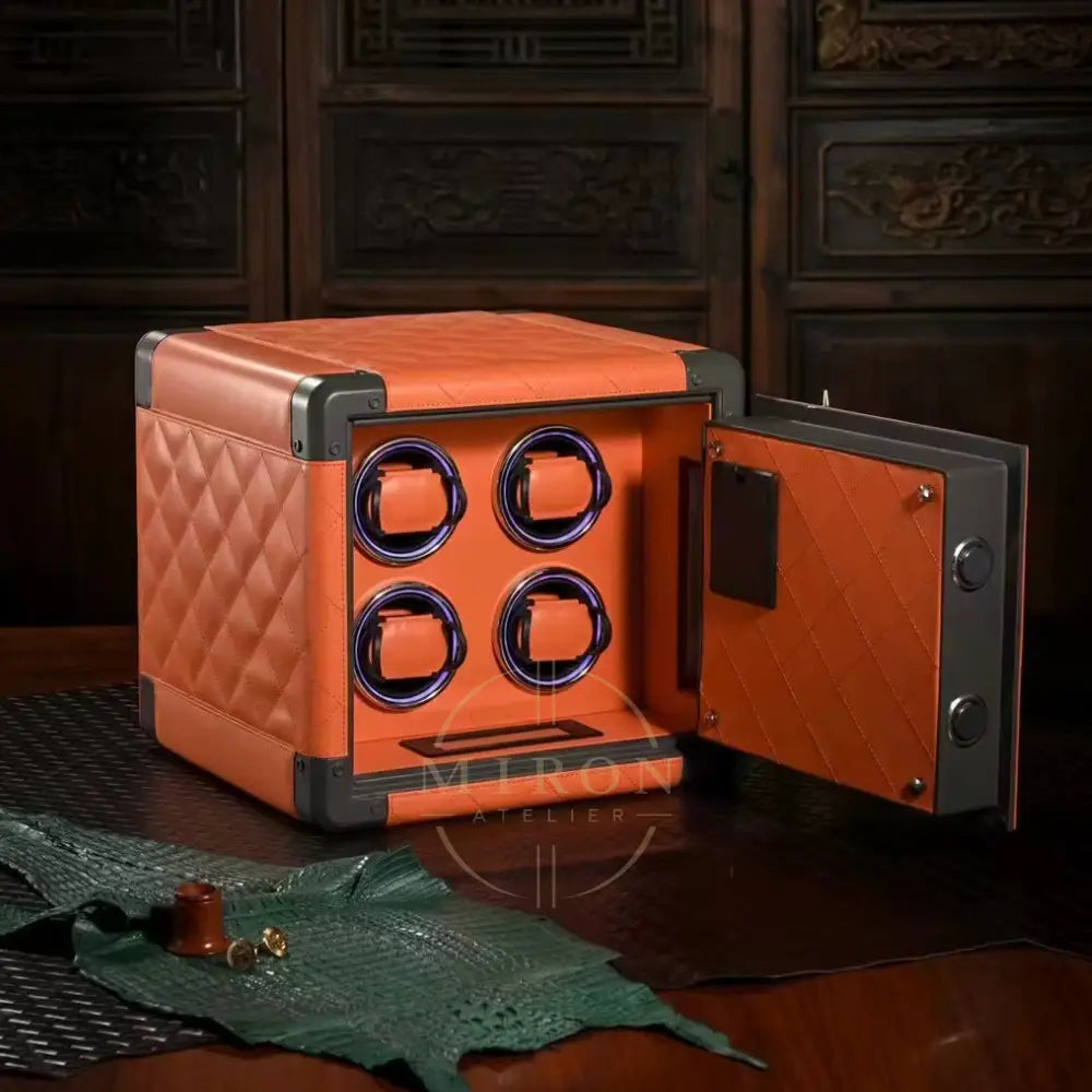 Orange watch winder with open door on a wooden surface
