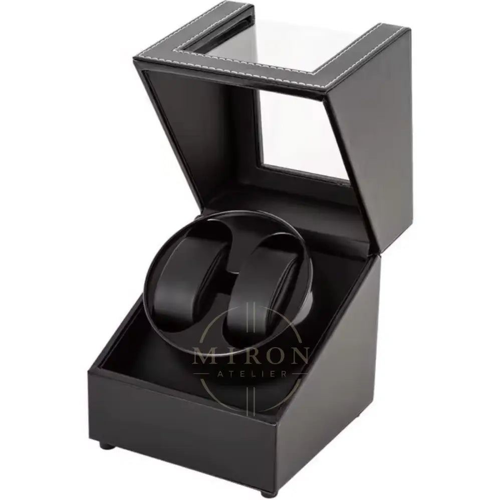 Black watch winder in an open display case on a white background