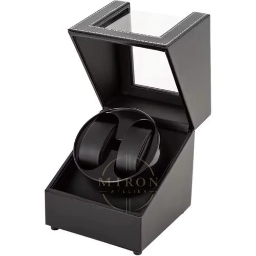 Black watch winder in an open display case on a white background