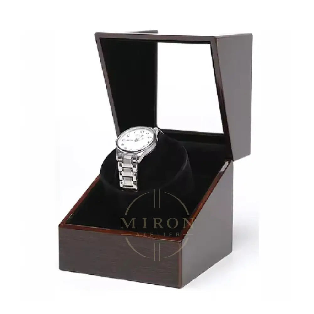 Silver watch in a wooden watch winder box with a white background