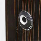 Close-up of a wooden surface with a circular metallic handle.