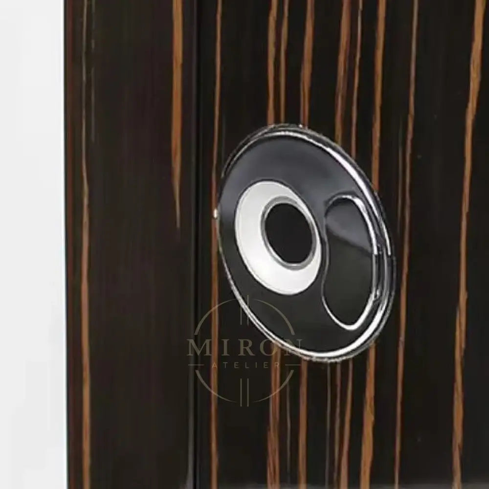 Close-up of a wooden surface with a circular metallic handle.