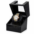 Gold and silver Seiko watch in a black crocodile watch winder patterned box on a white background
