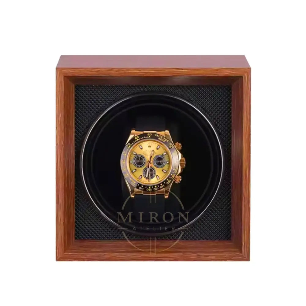 Rolex Daytona watch in a black watch winder case within a wooden box on a white background