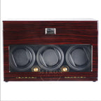 Wooden watch winder with three compartments on a white background