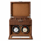 Brown leather watch winder box with two vintage luxury watches inside